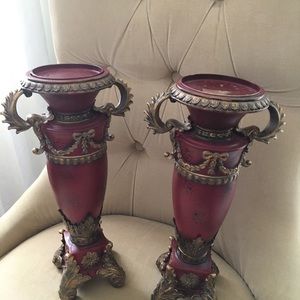 Red candle holder with brass accent.